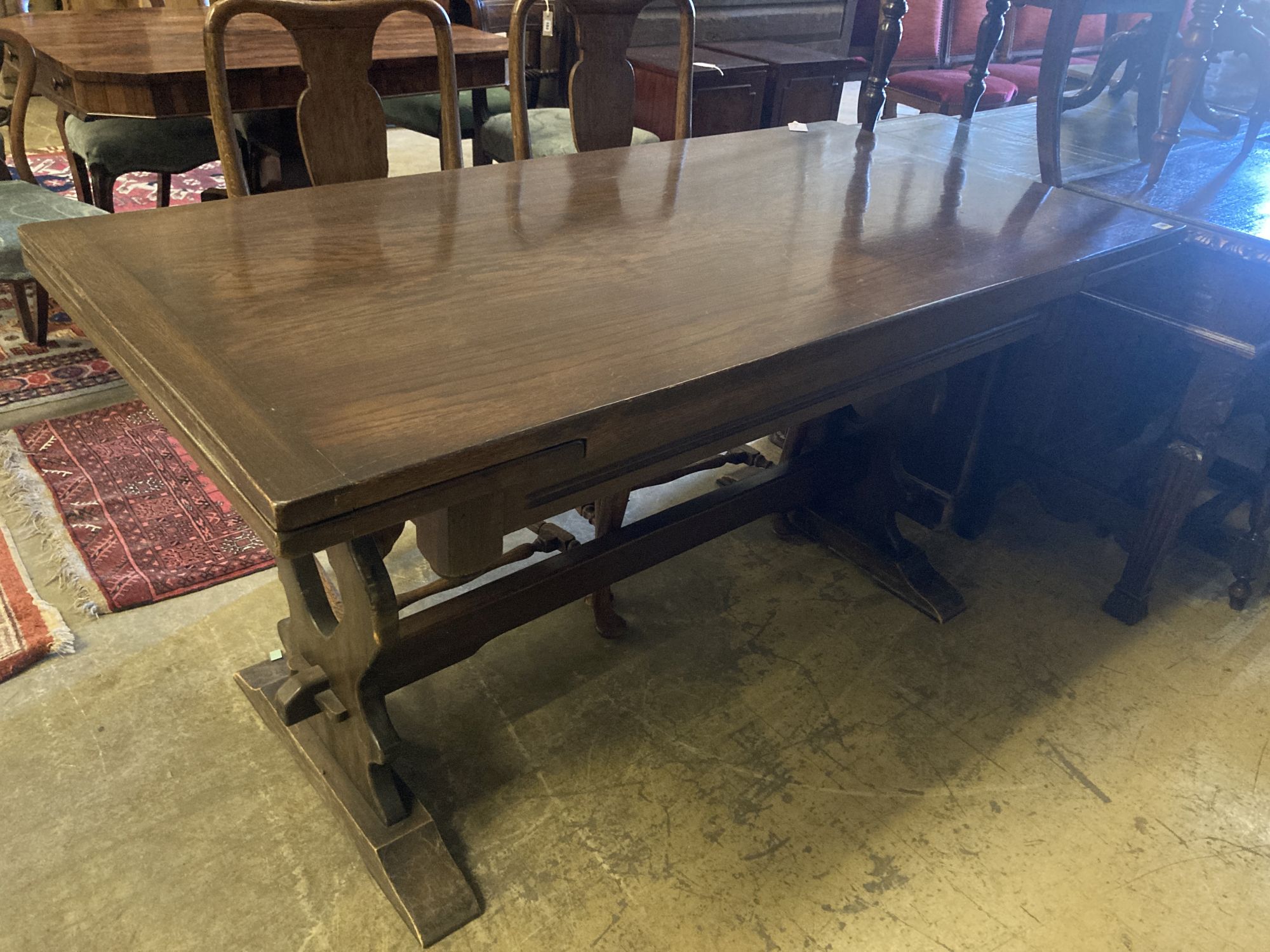 An 18th century style oak draw leaf dining table, width 150cm, depth 75cm, height 77cm